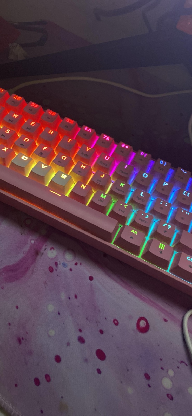 Rainbow-lit GK61 with white keycaps on a marbled pink desk mat